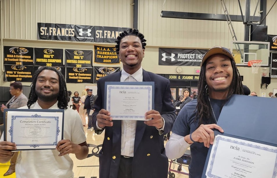 students with their diplomas at graduation