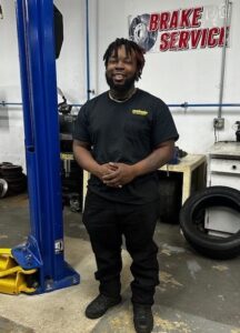 a man standing in an automotive repair shop