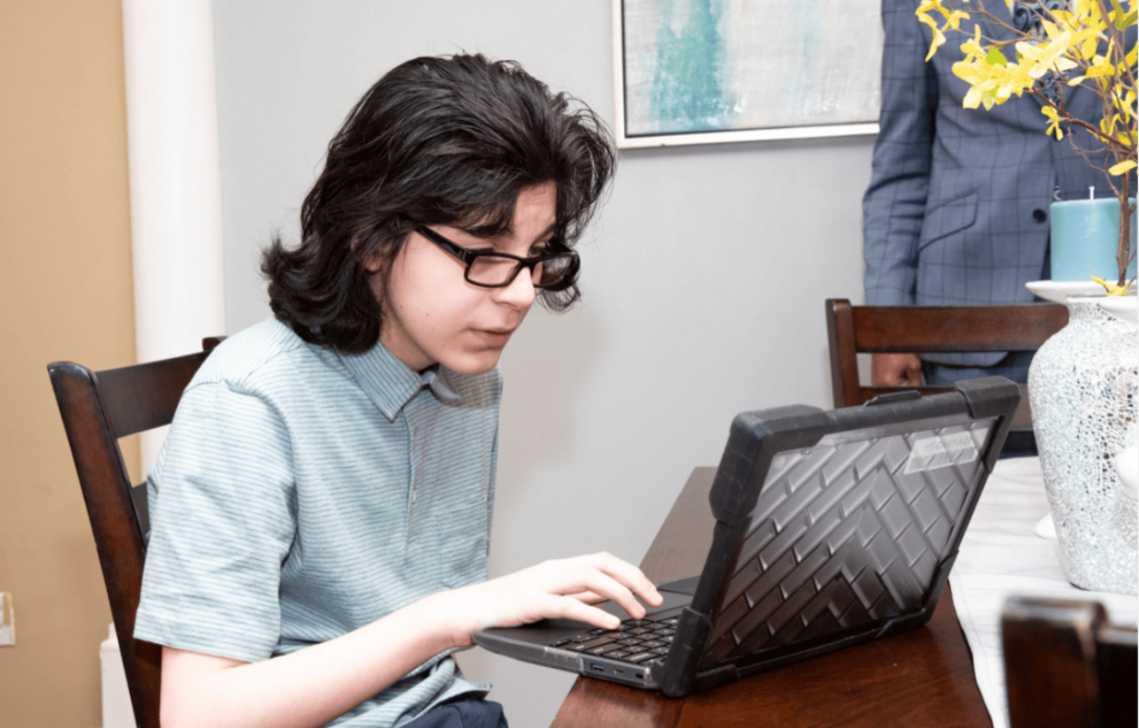 student in glasses at a computer